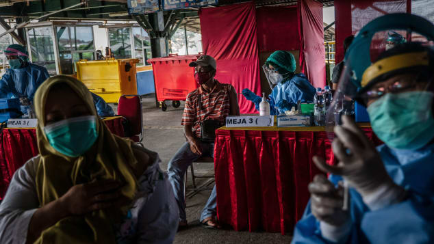 A man receives a dose of Sinovac Covid-19 vaccine during mass vaccination program on March 2, 2021 in Yogyakarta, Indonesia. 