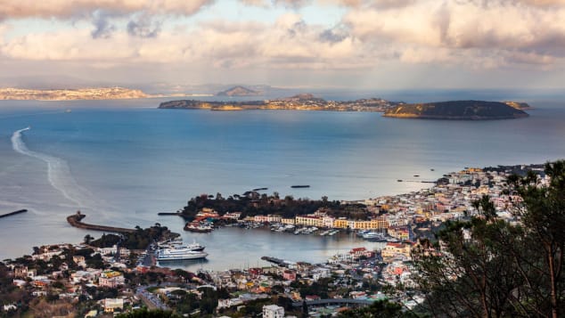The port of the volcanic island of Ischia (front) and the island of Procida (back) are pictured in the Bay of Naples, off Italy's western coast on the Tyrrhenian Sea, on March 4, 2019. (Photo by Laurent EMMANUEL / AFP) (Photo credit should read LAURENT EMMANUEL/AFP via Getty Images)
