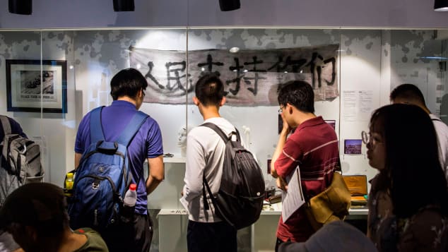 Visitors look at artefacts recovered from the scene of the 1989 Tiananmen Square crackdown on display at the June 4 Museum in Hong Kong on June 4, 2019.