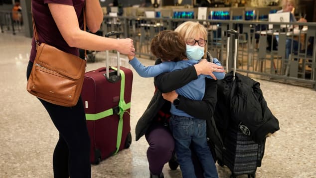 A woman arriving from Germany hugs a grandson she has not seen in three years at Dulles International Airport in Virginia on Monday.