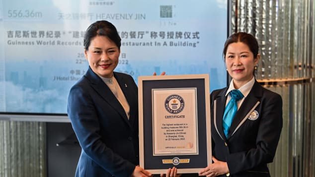 General manager of the J Hotel Shanghai Tower, Jenny Zhang (left) receives the Guinness World Record certificate for highest restaurant in a building. 