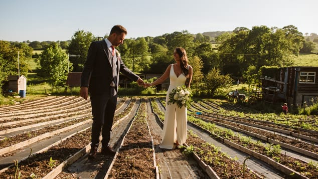 The couple, seen here in Gostling's asparagus field, hosted a small outdoor ceremony for 12 people and then a larger celebration in September 2021. 