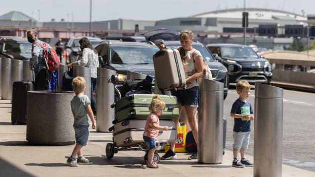 A passengers deals with luggage and kids at busy Newark Liberty International Airport in New Jersey on July 1. 