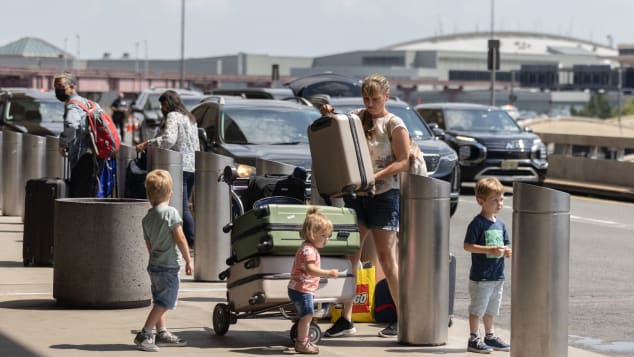 A passengers deals with luggage and kids at busy Newark Liberty International Airport in New Jersey on July 1. 