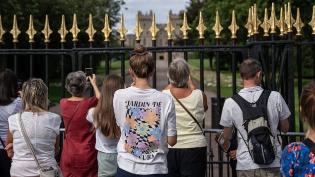 Mourners stand outside the gates of Windsor Castle in the UK following the death of Queen Elizabeth II on September 12, 2022.