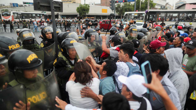 Demonstrators clash with police during a protest in Lima on Thursday.