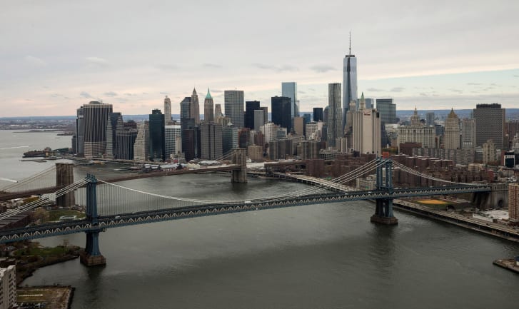 One World Trade Center, the tallest building in the Western Hemisphere, is  seen behind the Manhattan and Brooklyn bridges.