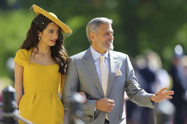 Amal Clooney (L) wore Stella McCartney as she arrived with husband George Clooney for the wedding ceremony on Saturday morning.