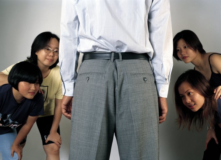 A image by photographer Hu Jieming from the controversial 1999 exhibition "Wushirenfei." An accompanying picture reveals luxury brands stitched to the man's crotch.