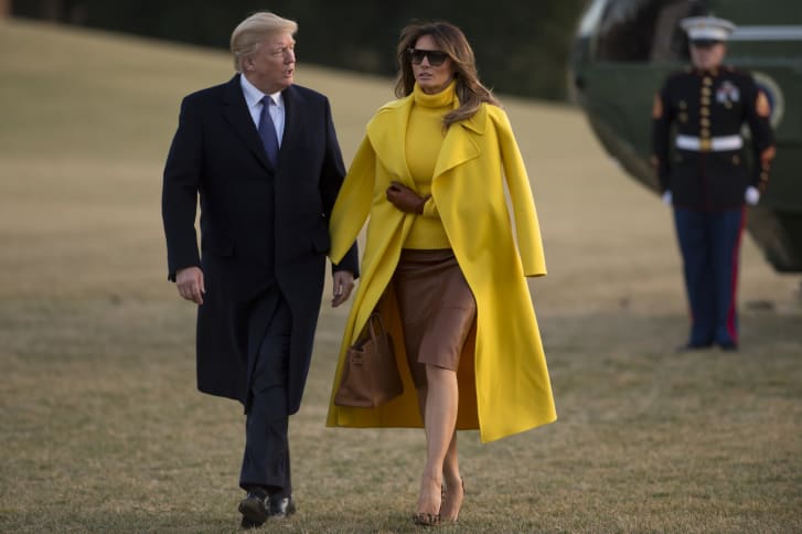 Trump walks across the South Lawn with her husband in February 2018. Since becoming First Lady, modest pencil skirts and blouses have become her go-to garments.