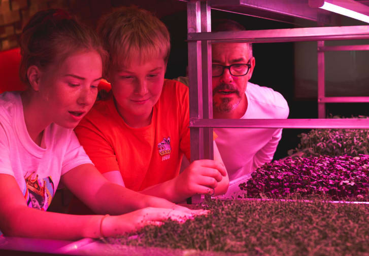 18 Family looks at hydroponic farming units by GrowStac