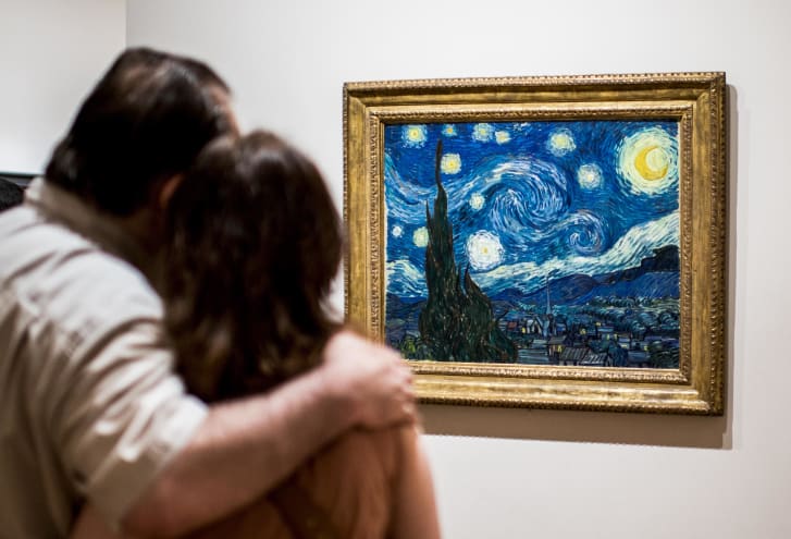 Tourists look at "The Starry Night" by Vincent Van Gogh at Museum of Modern Art in New York.