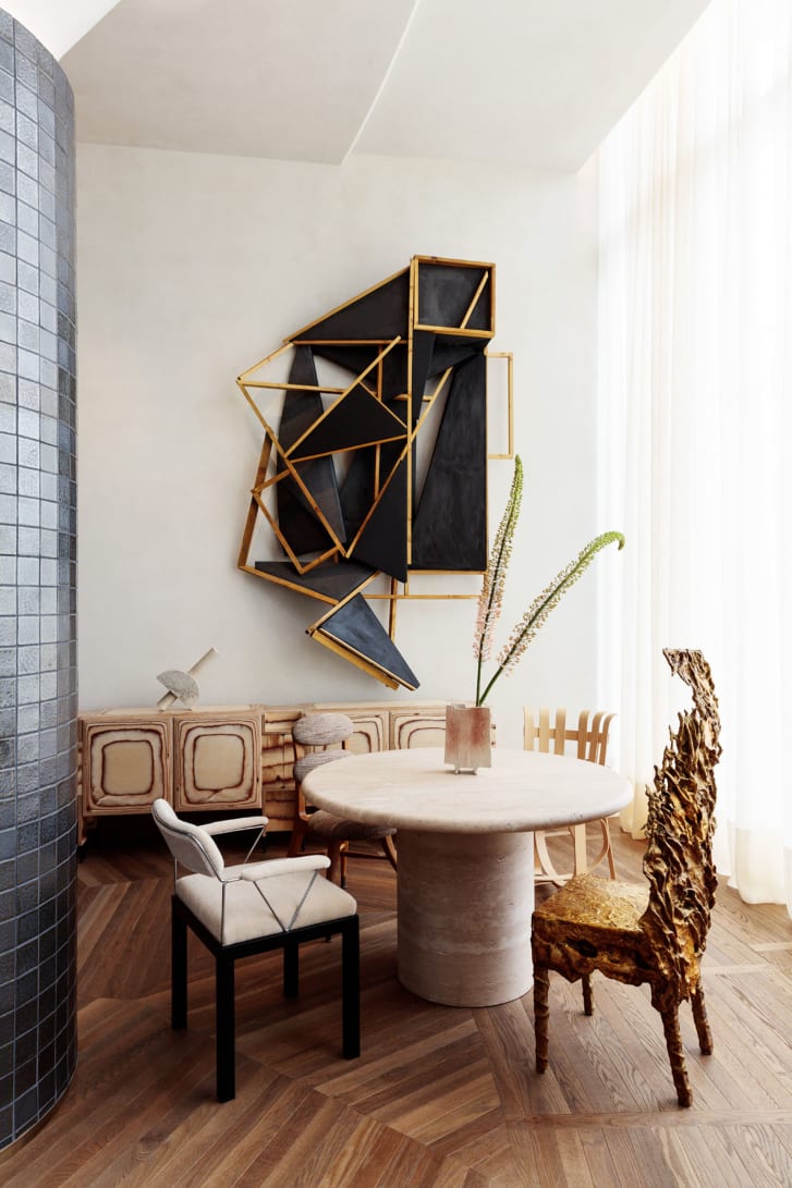 Concierge seating area at Santa Monica Proper Hotel. Vintage pieces include a gold leaf chair, a ceramic vase, an upholstered vintage Sottsass Associati "Lodge Chair" and a Frank Gehry "Hat Trick" chair.