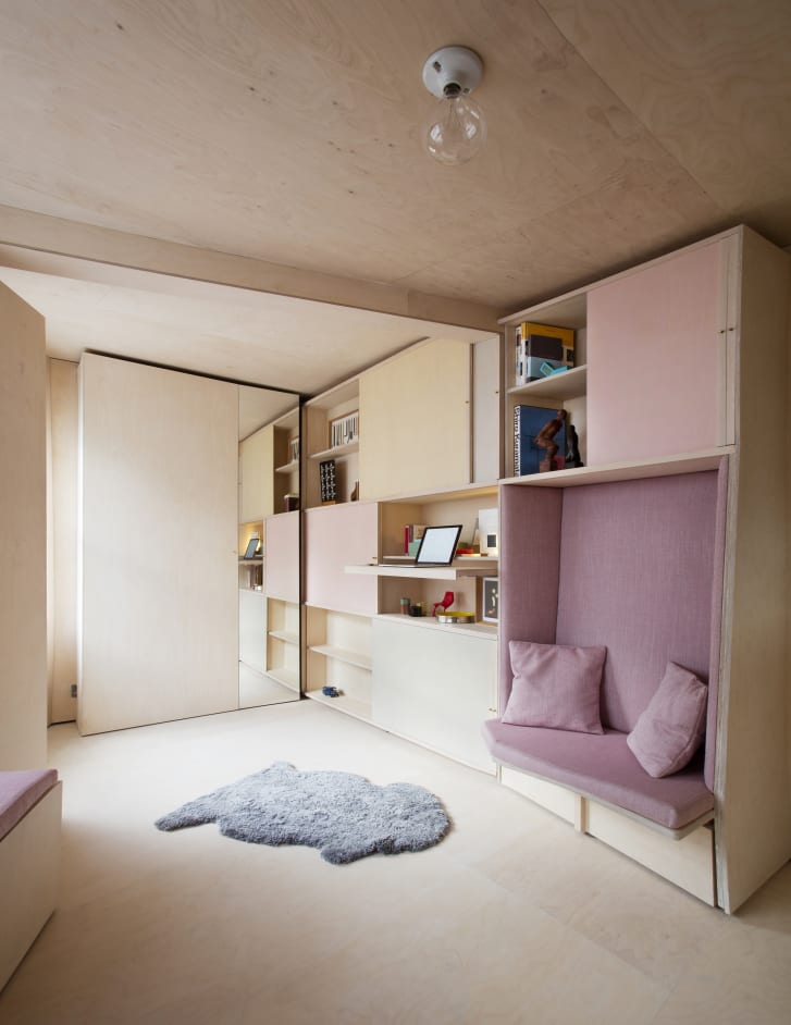 London-based design firm Studiomama created a small working area that folds into the wall in this 140-square-foot apartment project.