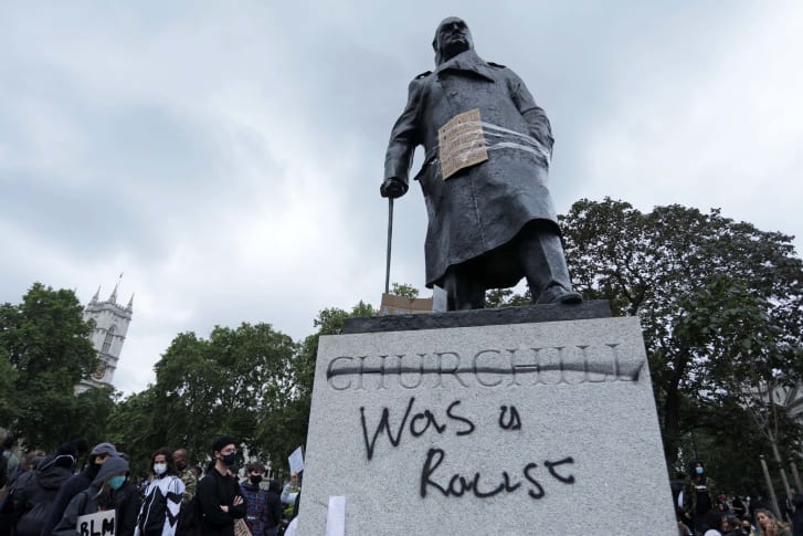 A statue of Winston Churchill in London's Parliament Square is seen defaced with the words "was a racist" written after his name,  following a Black Lives Matter demonstration on June 7, 2020.