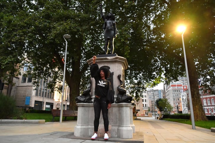 Jen Reid poses by the statue on Wednesday.