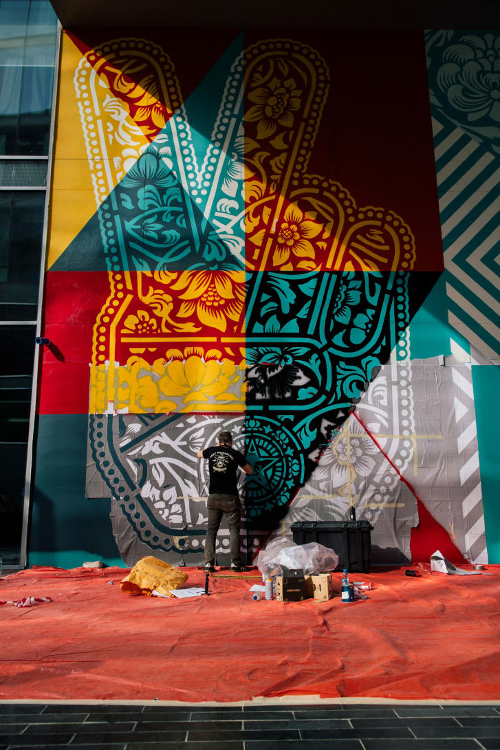 Shepard Fairey painting his first mural in the Middle East at Dubai Design District.