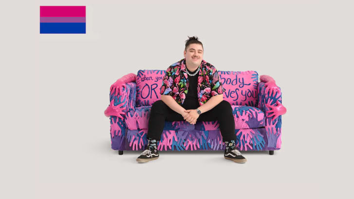 Spoken word poet Brian Lanigan pictured on IKEA's "bisexual" couch, which was inspired by his work.