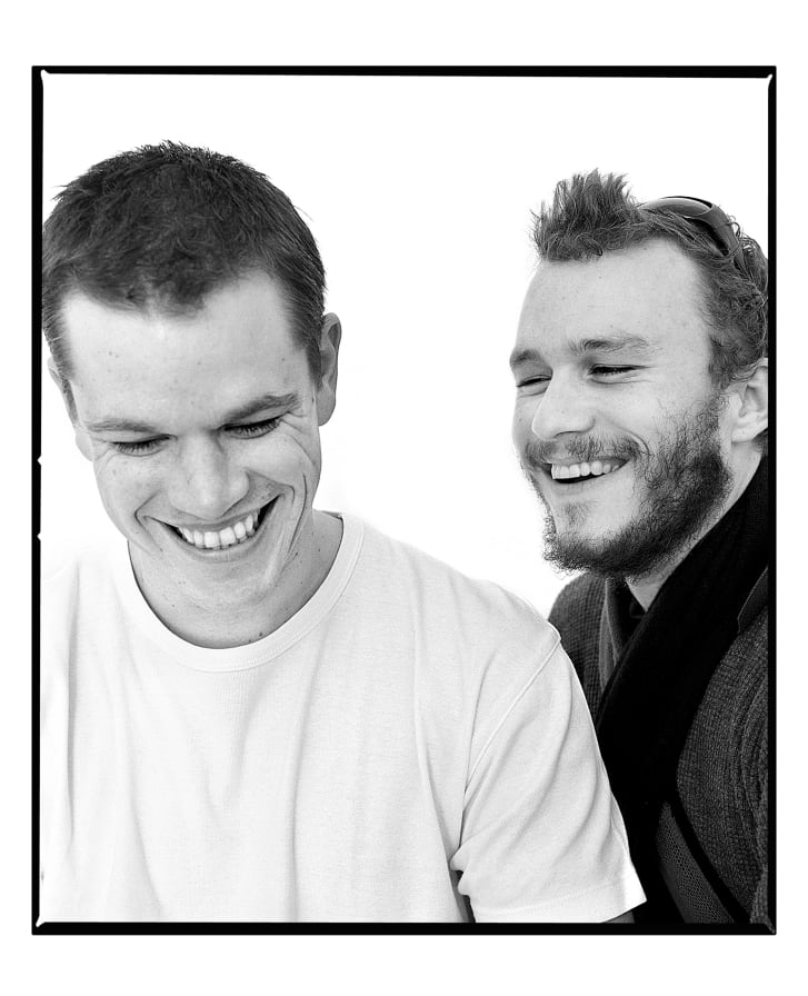 Matt Damon and Heath Ledger laughing on set, after Ledger interrupted a photoshoot.