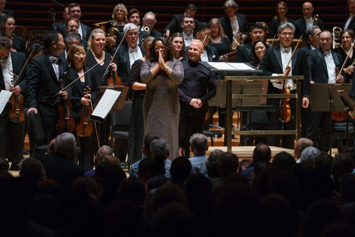 Valerie Coleman stands with the Philadelphia Orchestra after the world premiere of "Umoja"