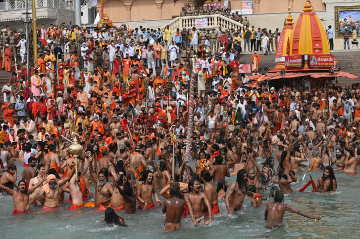 Hindu holy men take a dip in the Ganges River during the religious Kumbh Mela festival, in Haridwar on April 12, 2021. 