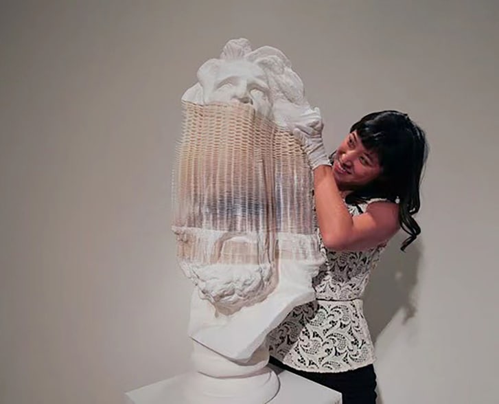 Working with the Eli Klein Gallery, Christina Yuna Lee handles a sculpture by Chinese artist Li Hongbo in 2013. She worked as an associate director at the gallery.