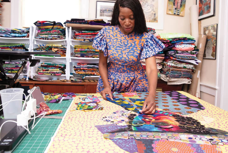 Bisa Butler working with fabrics.