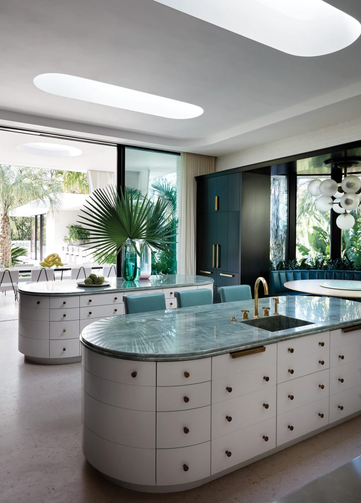 In the kitchen, lozenge-shaped skylights mirror the kitchen islands below, which are topped in emerald quartzite.