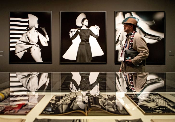 A visitor passes by several works of US contemporary photographer William Klein during a press preview, on display at the exhibition 'William Klein at the cultural center of La Pedrera in Barcelona, Catalonia, northeastern Spain on March 5, 2020.