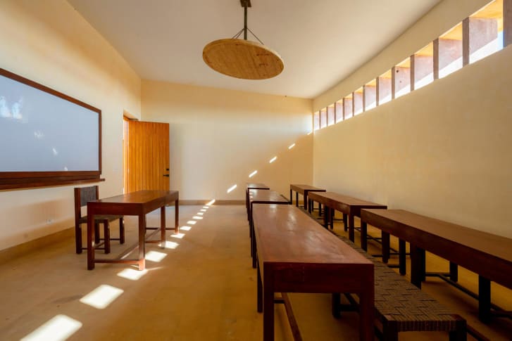 High ceilings and windows help release trapped heat in classrooms.