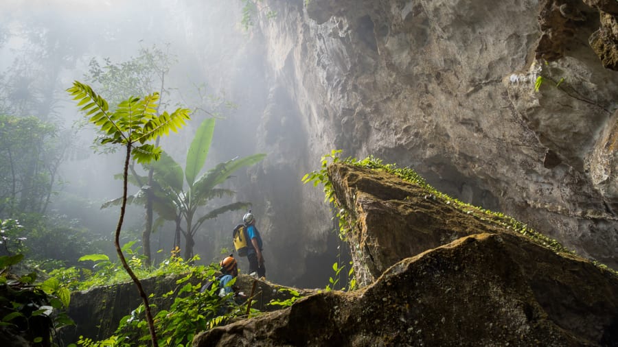 Hang Son Doong is so massive that it contains its own jungle, underground river and localized weather system. Clouds form inside the cave and spew out from the exits and dolines, which gave the first explorers a clue as to how large Hang Son Doong really is | Alesha Bradford