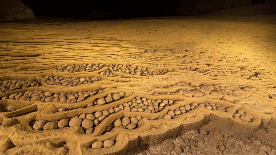 Not all of the magnificent formations that can be found in Hang Son Doong are massive. Towards the end of the chambers rare, spherical "cave pearls" are also found. These are formed when tiny pieces of sediment collect calcium salt layers over thousands of years | Jarryd Salem/CNN