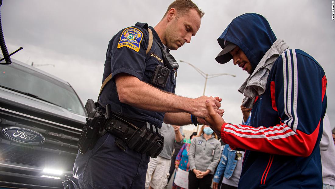 Some police officers are showing solidarity with protesters in several US cities