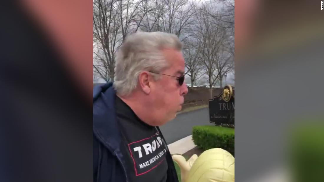 A man wearing Trump gear who was seen deliberately exhaling on women outside Trump golf club has been charged
