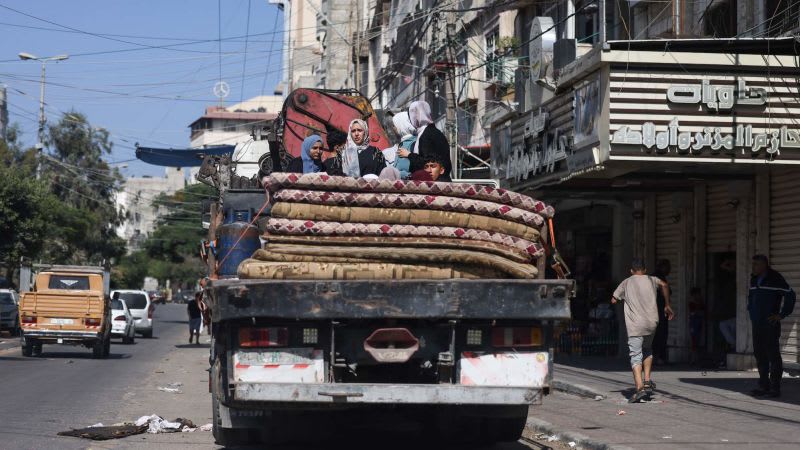 Tens of thousands flee south in bombarded Gaza as Israeli troops gather near border | CNN