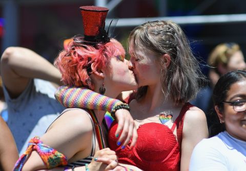 A couple kisses during the march. Angela Weiss/AFP/Getty Images