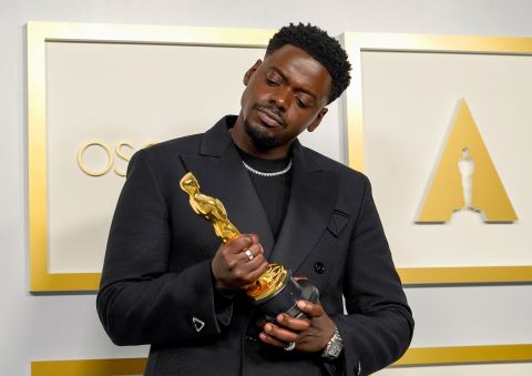 Daniel Kaluuya examines his best supporting actor Oscar, which he won for his role as Black Panther leader Fred Hampton in 'Judas and the Black Messiah.' Chris Pizzello/Pool/Getty Images