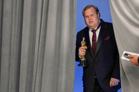 Phillip Bladh, holding the best sound Oscar for 'Sound of Metal,' enters the press room in Los Angeles. Chris Pizzello/Pool/Getty Images