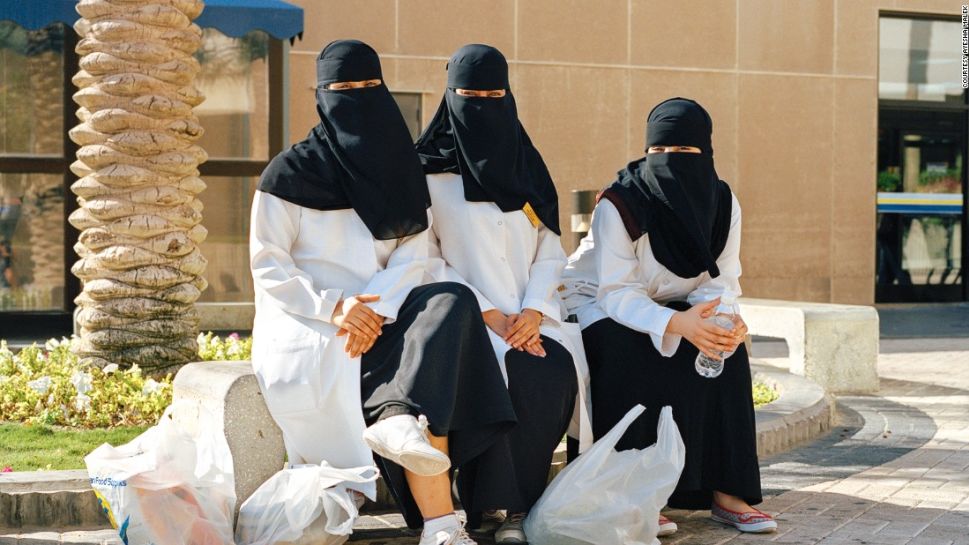 Nurses from Dhahran Health Center waiting for a bus outside the commissary.